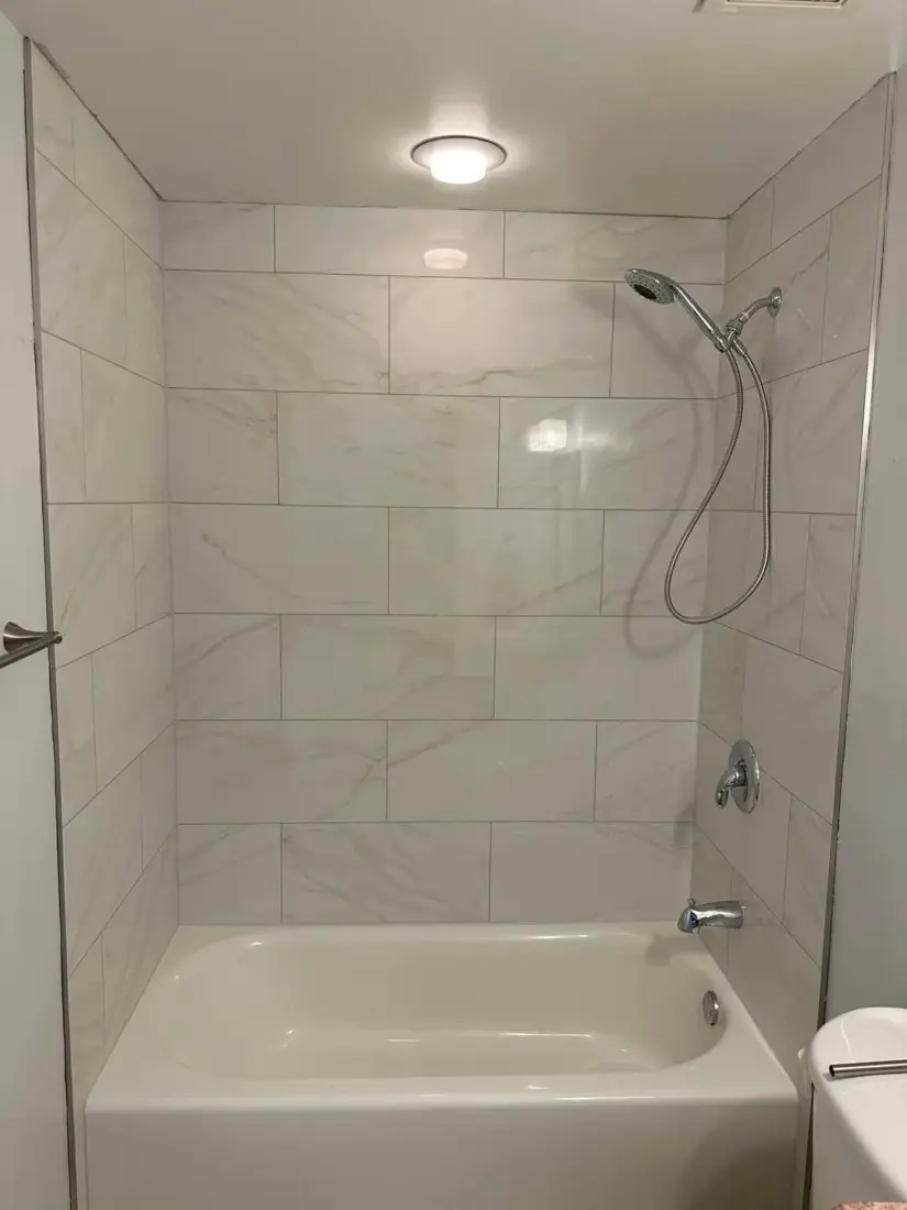 After: Bath surround in large-format tiles