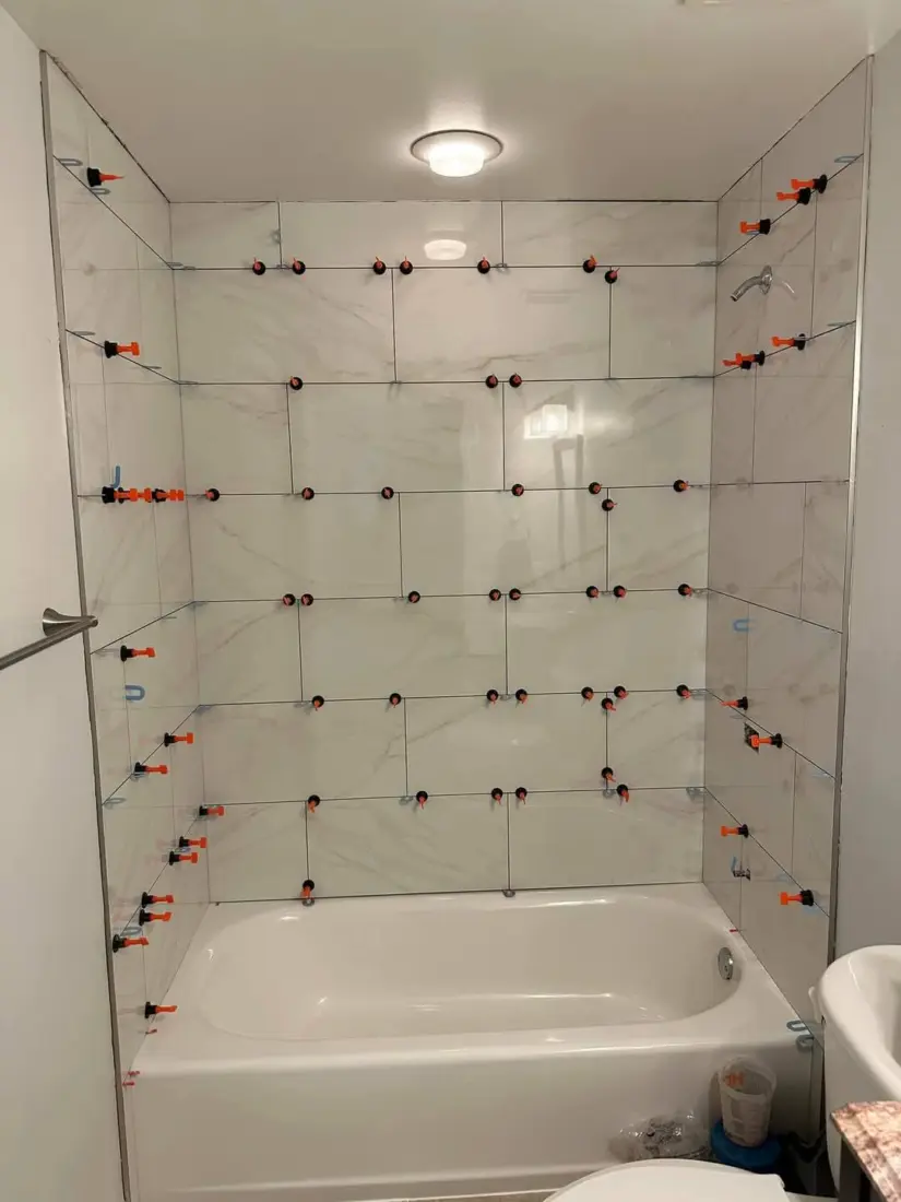 Before: Bath surround in large-format tiles